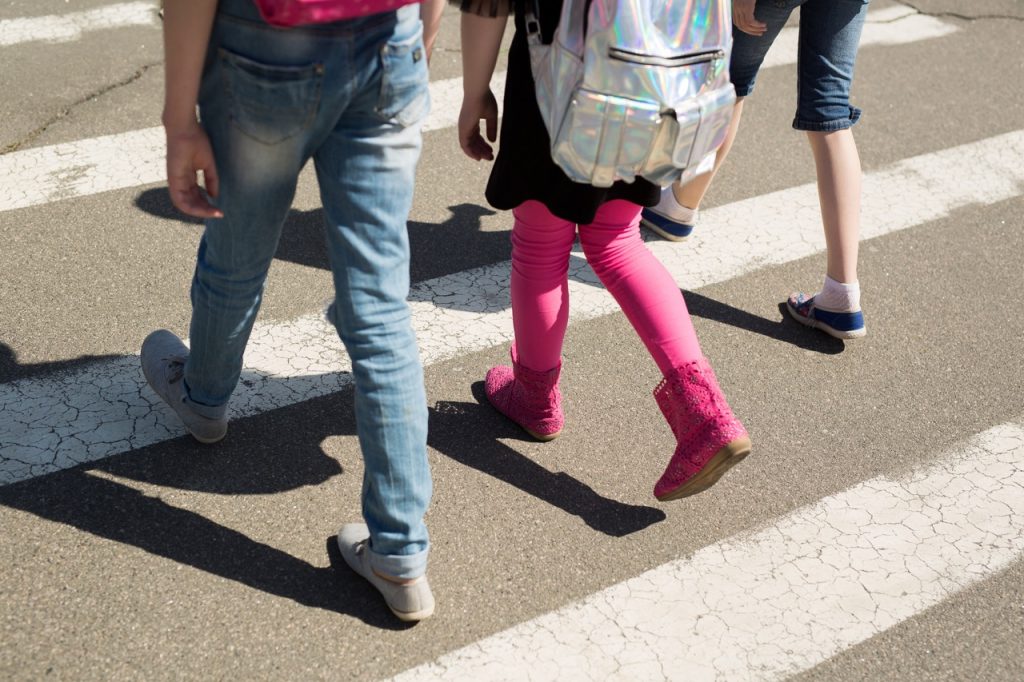 Schoolchildren crossing the road on their way to school.